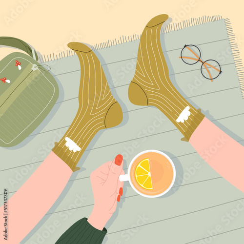 Vector illustration with female hand holding mug with coffee and feet in green socks. Top view, cute heart made of coffee foam. Concept of warmth and comfort of winter and autumn days