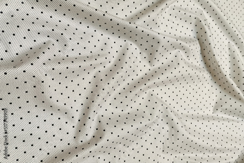 White poplin with black dots. Crumpled or wavy fabric texture background. Abstract linen cloth soft waves. Natural yarn. Smooth elegant luxury cloth texture. Concept for banner or advertisement.