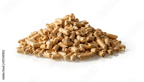 Heap of wood pellets isolated on a white background. Pile of compacted sawdust granules cutout. Ecological biofuel made from compressed sawdust. Natural renewable energy concept. Closeup.