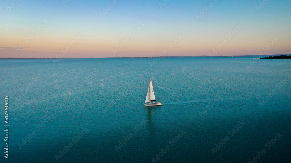 aerial view of sailboat at sunset