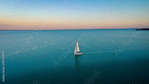aerial view of sailboat at sunset