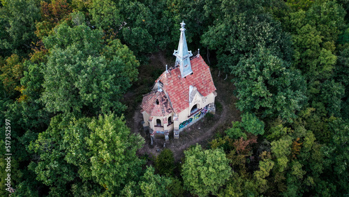 aerial view of a ruined church in the forest