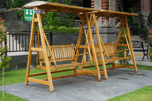 Wallpaper Mural Wooden swing in the middle of the garden, with the note "Swings for children" Torontodigital.ca