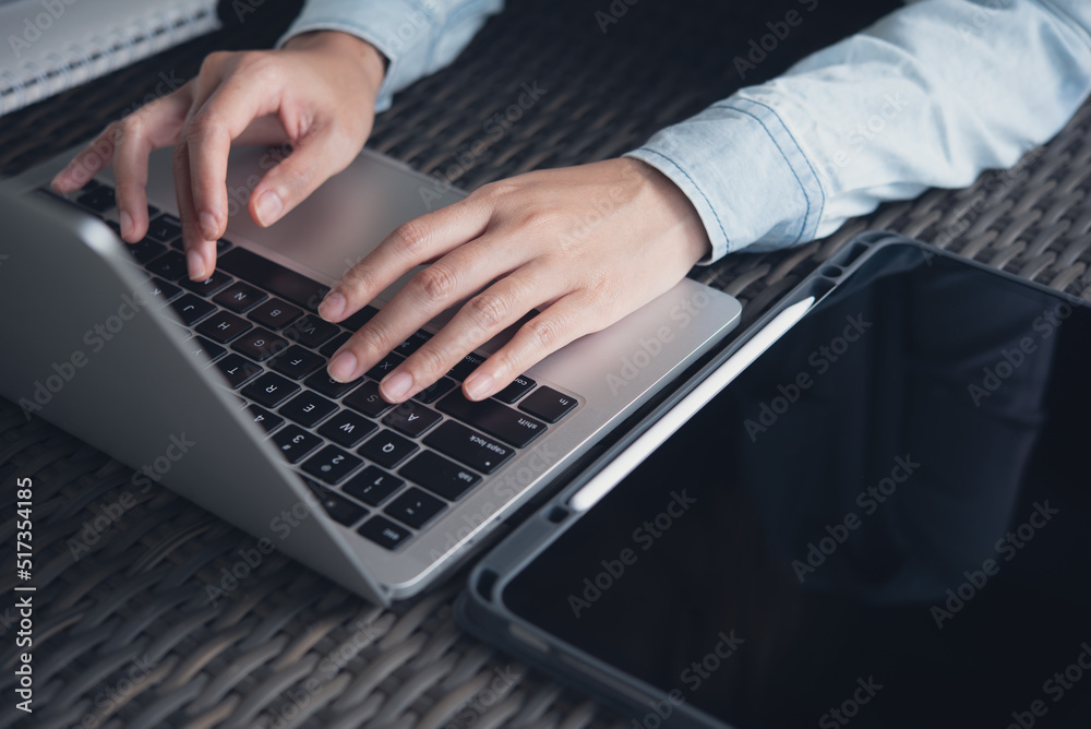 Woman hands typing on laptop computer keyboard on table at the office, Woman worker online working from home, distance job, telecommuting Woman hands typing on laptop computer keyboard on table at the office, Woman worker online working from home, distance job, telecommuting