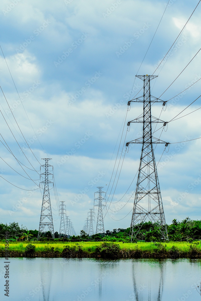 High-voltage transmission towers, complex steel structures in rural areas of Thailand.