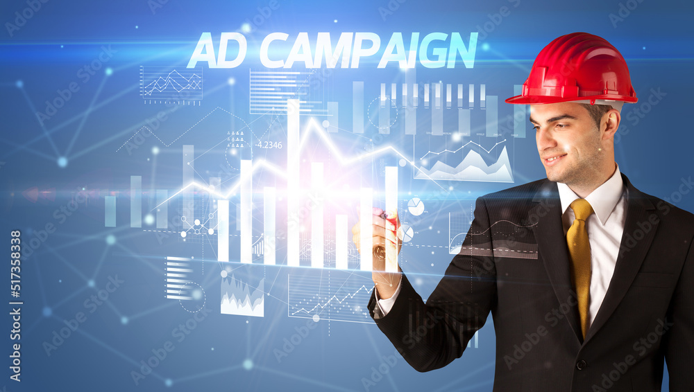 Young businessman with helmet drawing on virutal screen Young businessman with helmet drawing on virutal screen