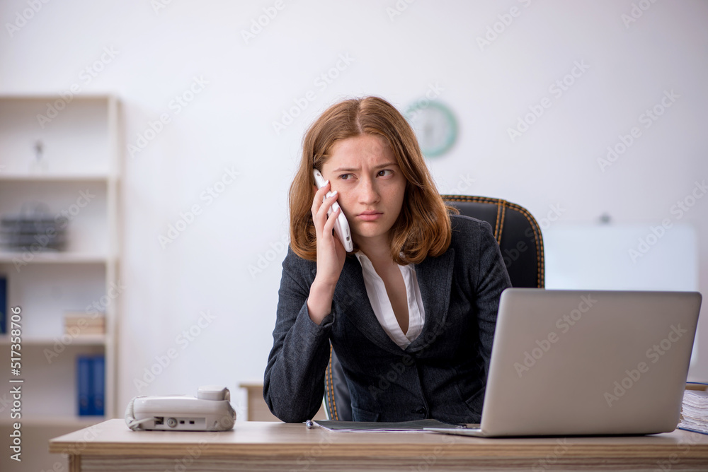 Young female employee working in the office Young female employee working in the office
