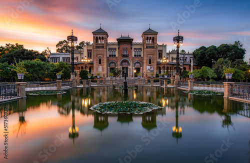 Museum of Popular Arts and Traditions reflecting in the near fountain in Seville, Andalusia, Spain.