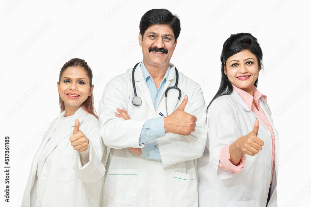 Portrait happy indian male and female doctors with stethoscope standing doing thumbs while looking at camera, healthcare and medical concept. Portrait happy indian male and female doctors with stethoscope standing doing thumbs while looking at camera, healthcare and medical concept.