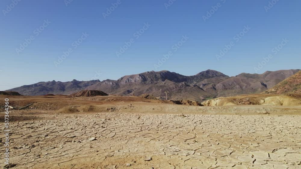 Aerial view old abandoned mines of Mazarron in Murcia on blue sky background during sunny summer day. Dry land textured surface background. Mineral extraction industry, history concept. Spain Aerial view old abandoned mines of Mazarron in Murcia on blue sky background during sunny summer day. Dry land textured surface background. Mineral extraction industry, history concept. Spain