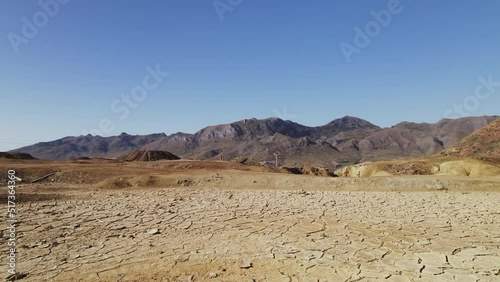 Aerial view old abandoned mines of Mazarron in Murcia on blue sky background during sunny summer day. Dry land textured surface background. Mineral extraction industry, history concept. Spain photo