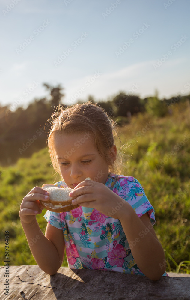 Girl holding sandwich with white bread. Snack on a picnic. Girl holding sandwich with white bread. Snack on a picnic.