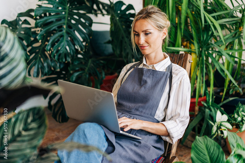 Saleswoman working on a laptop making an online order in an online store.