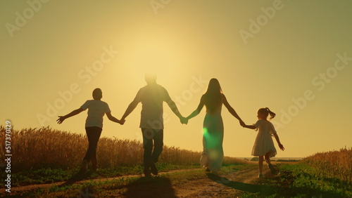 Happy family of farmers with children go through wheat field. Slow motion. Mom, dad and child are walking together. Healthy mother, father, little daughter play enjoy nature outdoors, Dreams of flying © zoteva87
