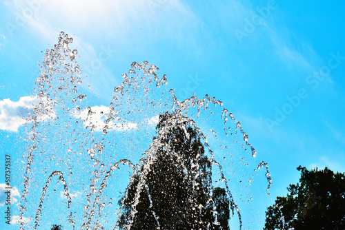 close-up water jet fountain against blue sky