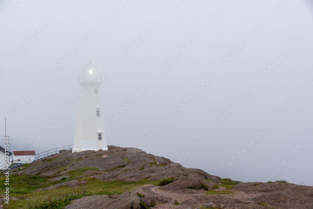 The lighthouse at Cape Spear, Newfoundland, the easternmost point in North America, is seen drenched in a thick layer of fog.