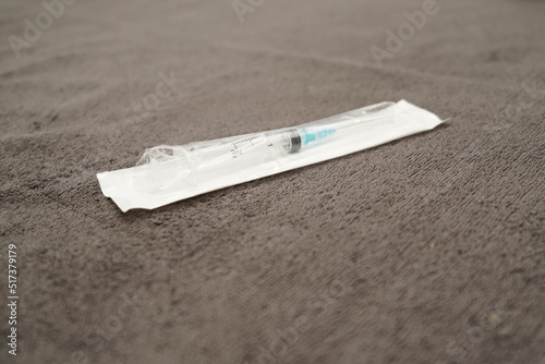 An injection needle lying on a cosmetology bed ready for the antiaging procedures