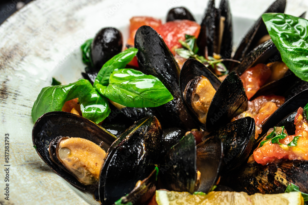 dish of mussels with lemon and baguette. Clams in the shells. Restaurant menu, dieting, cookbook recipe top view dish of mussels with lemon and baguette. Clams in the shells. Restaurant menu, dieting, cookbook recipe top view