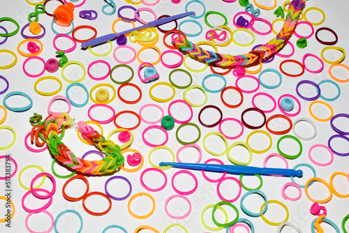 Multi-colored rubber bands for children's creativity lie on a white. photo