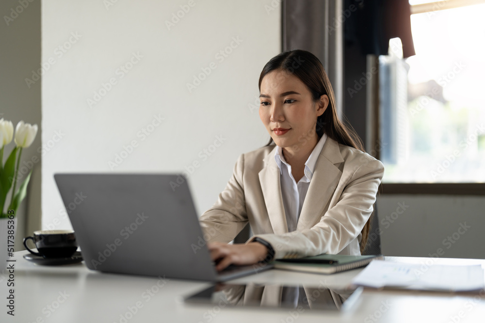 Portrait of happy millennial asian businesswoman work on laptop online at home office. smiling young woman employee or worker consult client partner distant on computer. Technology concept. Portrait of happy millennial asian businesswoman work on laptop online at home office. smiling young woman employee or worker consult client partner distant on computer. Technology concept.