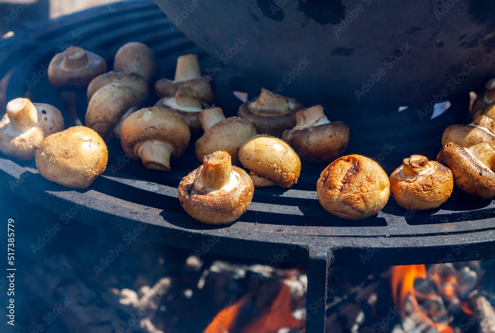 Stuffed portobello mushrooms black fire flames background hot BBQ