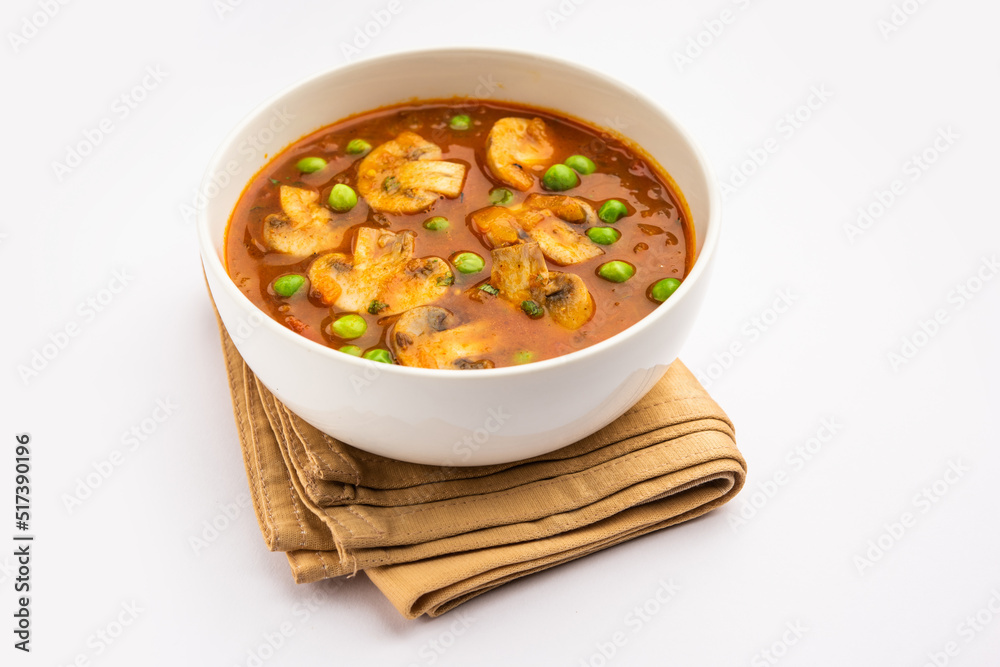 Mushroom and Pea Curry with Roasted Garlic, Indian food served in a bowl Mushroom and Pea Curry with Roasted Garlic, Indian food served in a bowl