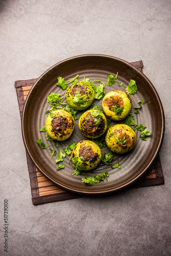 Indian style Tinda or Tinde ki Sabzi also called Indian squash, round melon, Indian round gourd or Indian baby pumpkin, stuffed, stir fried dry or curry recipe photo