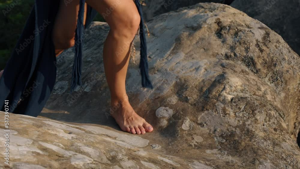 Walking barefoot on rocky terrain in the mountains close-up of a female walking in bare feet Walking barefoot on rocky terrain in the mountains close-up of a female walking in bare feet