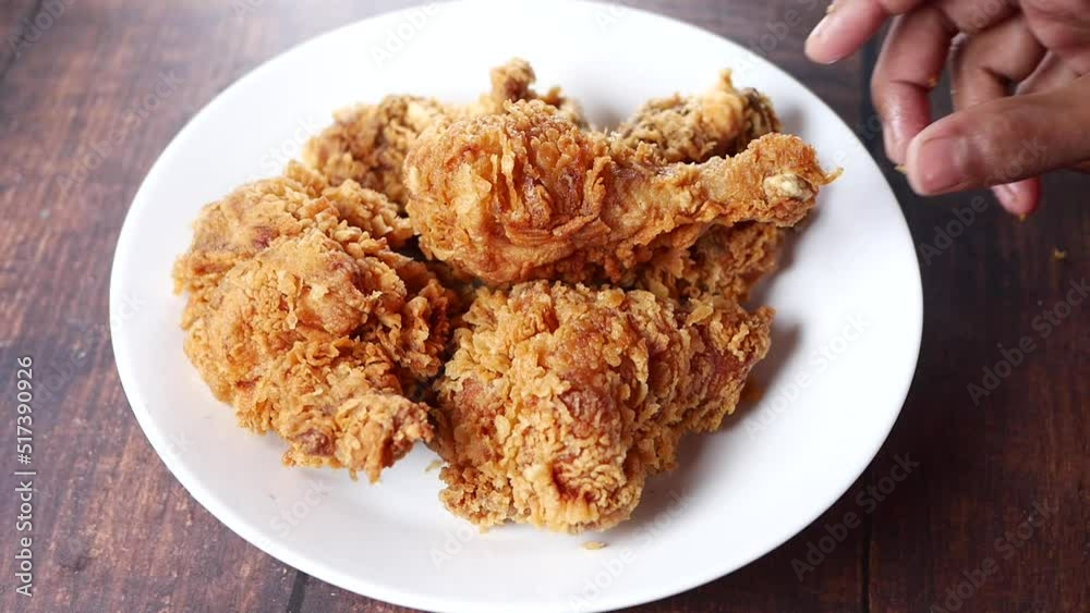 hand pick a fried chicken fillets on plate hand pick a fried chicken fillets on plate