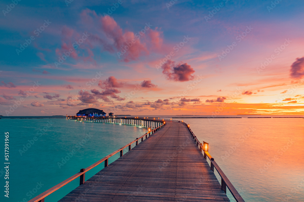Beautiful Maldives paradise sunset. Tropical aerial landscape, seascape, water villas amazing sea sky, lagoon beach, tropical nature. Exotic tourism destination, summer aerial vacation, drone view.
