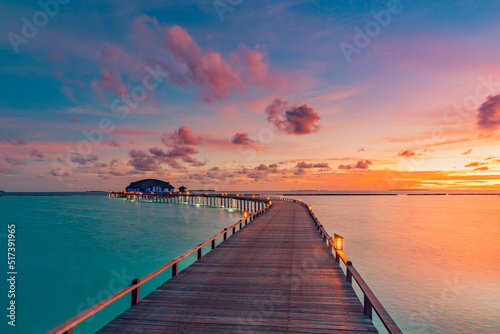 Beautiful Maldives paradise sunset. Tropical aerial landscape, seascape, water villas amazing sea sky, lagoon beach, tropical nature. Exotic tourism destination, summer aerial vacation, drone view. 