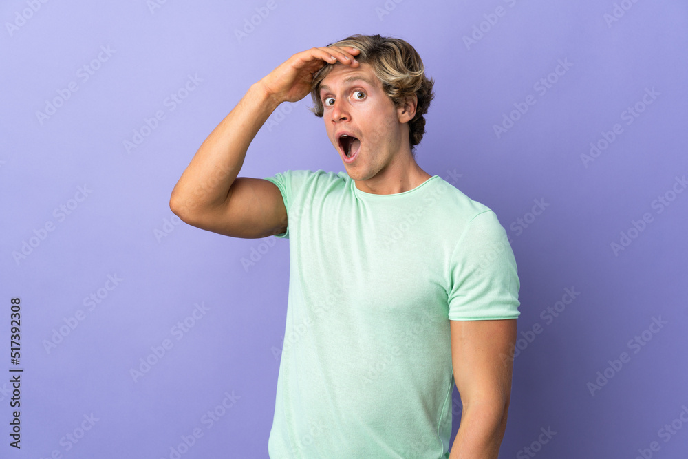 English man over isolated purple background doing surprise gesture while looking to the side English man over isolated purple background doing surprise gesture while looking to the side