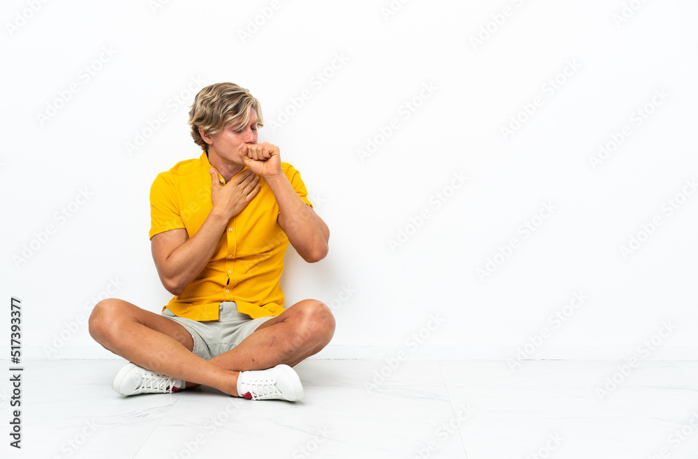 Young English man sitting on the floor coughing a lot Young English man sitting on the floor coughing a lot