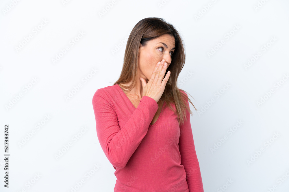 Middle age caucasian woman isolated on white background whispering something with surprise gesture while looking to the side Middle age caucasian woman isolated on white background whispering something with surprise gesture while looking to the side