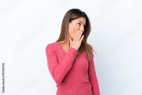 Middle age caucasian woman isolated on white background whispering something with surprise gesture while looking to the side