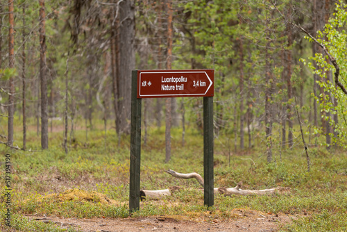 Signpost on the hiking trail in Lemmenjoki National Park in Finland.