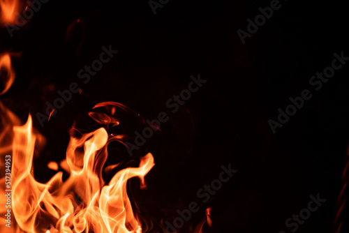 Beautiful campfire flame tonques isolated on black background with copyspace