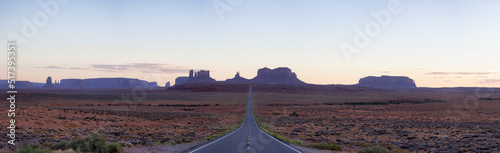Scenic Road in the Dry Desert with Red Rocky Mountains in Background. Sunset Sky. Forrest Gump Point in Oljato-Monument Valley, Utah, United States. Panorama