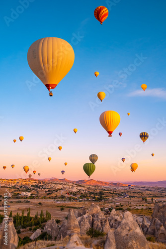 Hot air balloons flying on sunset sky in Cappadocia, Turkey photo