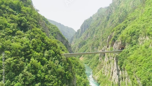 Aerial video. Shooting a beautiful gleby gorge and bridge on a sunny summer day photo