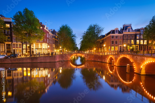 Amsterdam, Netherlands. View of houses and bridges during sunset. The famous Dutch canals and bridges. A cityscape in the evening. Travel photography.