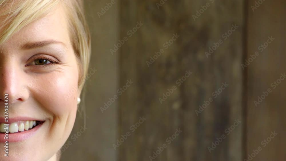 Half face of a happy female professor isolated on wooden background with copy space. One lecturer, educator or PhD supervisor with a big smile. Portrait of a confident woman feeling content Half face of a happy female professor isolated on wooden background with copy space. One lecturer, educator or PhD supervisor with a big smile. Portrait of a confident woman feeling content
