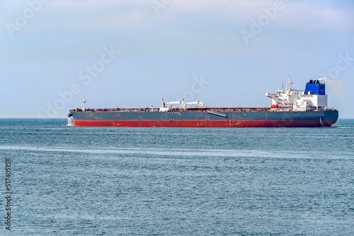 Crude oil tanker in navigation off the coast of The Netherlands on a partly cloudy summer day