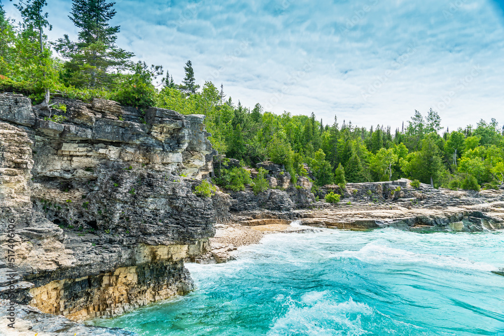 Indian Head Cove at Tobermory, turquoise blue water and green pine forest in Ontario Canada. Summer day at Bruce Peninsula National Park near Bruce trail, Georgian Bay Trail and Cyprus lake.