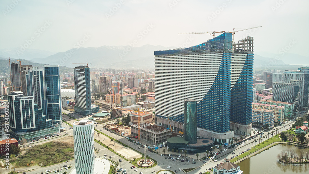 Obraz premium Aerial view of the modern architecture of Batumi with mountains background