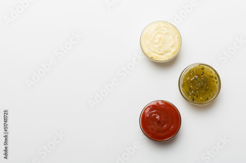 Different types of sauces in bowls on a colored Board . Top view. various sauces copy space