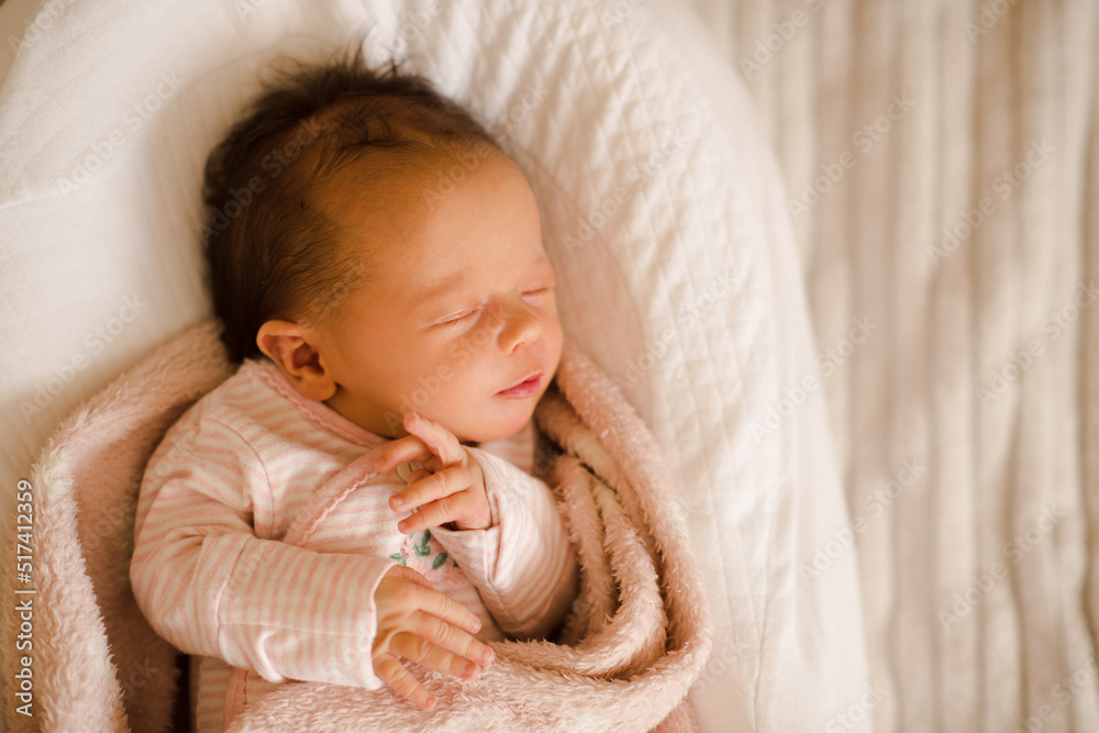 Sleeping baby girl wear pajamas lying in crib wrapped in blanket close up. Childhood. Sleeping baby girl wear pajamas lying in crib wrapped in blanket close up. Childhood.
