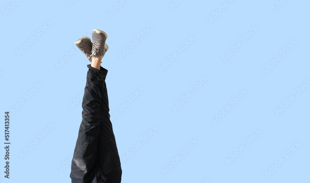 upside down person's legs in new pair of sneakers, trendy creative concept upside down person's legs in new pair of sneakers, trendy creative concept