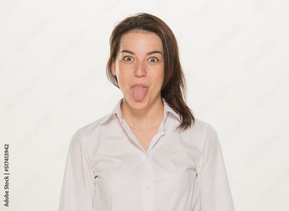 Obraz premium portrait of a girl in a white shirt isolated.close-up portrait of a young girl in a white shirt on a white background isolated.emotions joy happiness surprise calmness chagrin.win lose.