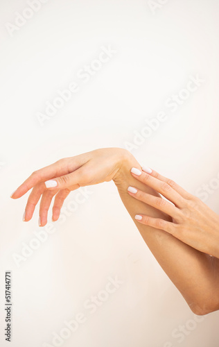 hands applying cream on skin
